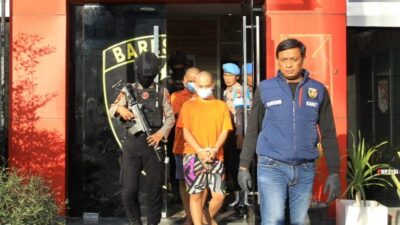Kanit Jatanras Ipda Mustofah mengiring pelaku menuju pres rilis di Mpolres Tanjung Perak (foto:Samsul-harianradar.com).