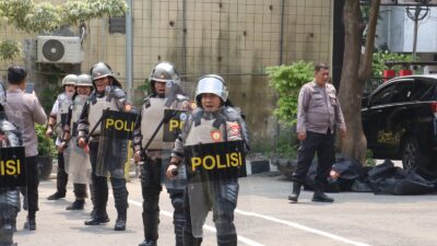 Kapolres Pelabuhan Tanjung Perak, AKBP Wahyu Hidayat, bersama Wakapolres dan seluruh Pejabat Utama (PJU) tampak mengenakan seragam taktis pasukan anti huru hara (PHH) lengkap.